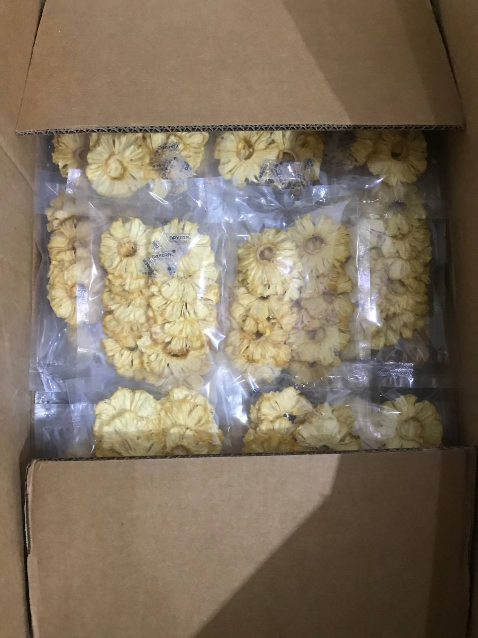 Dried pineapple rings vacuum stacked in boxes